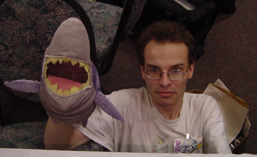 A hideous, gilled, sharp-teethed, sea-dwelling monster. Also pictured, a shark