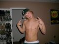 A true wigger. Note the hat, shirtlessness, and gay undies showing. Oh, and "deuces" and a "grill."