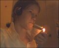 Stephanie, smoking on a cig between cocks.