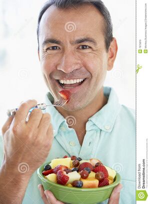 Middle-aged-man-eating-fresh-fruit-salad-7875816.jpg