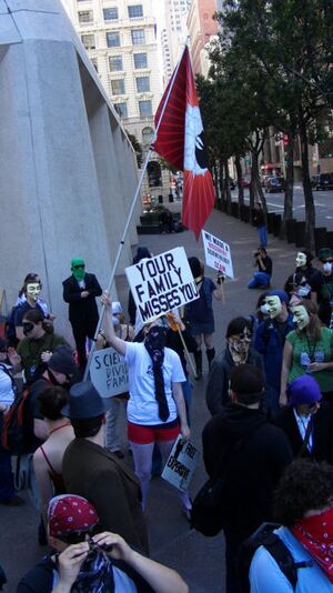 Anon holding white rose flag.jpg