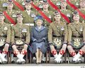 A kilt wearer exposes his genitals next to the queen of Britain.