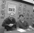 Even though this is a joint book signing, Stainek isn't sitting and the sign behind him only displays the other author's name. Hmmm...