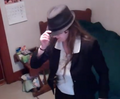 Tipping her fedora.