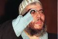 Abu Hamza al-Masri waves to his adoring fans