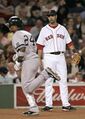 Later in that same game, Lowell watches Robinson round the bases after a home run.