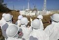 The Liquidators' lead painted suits barely protect them from the radiation at the site.