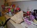 Empty soda bottles, dishes piled to the faucet, not a single shred of countertop visible.